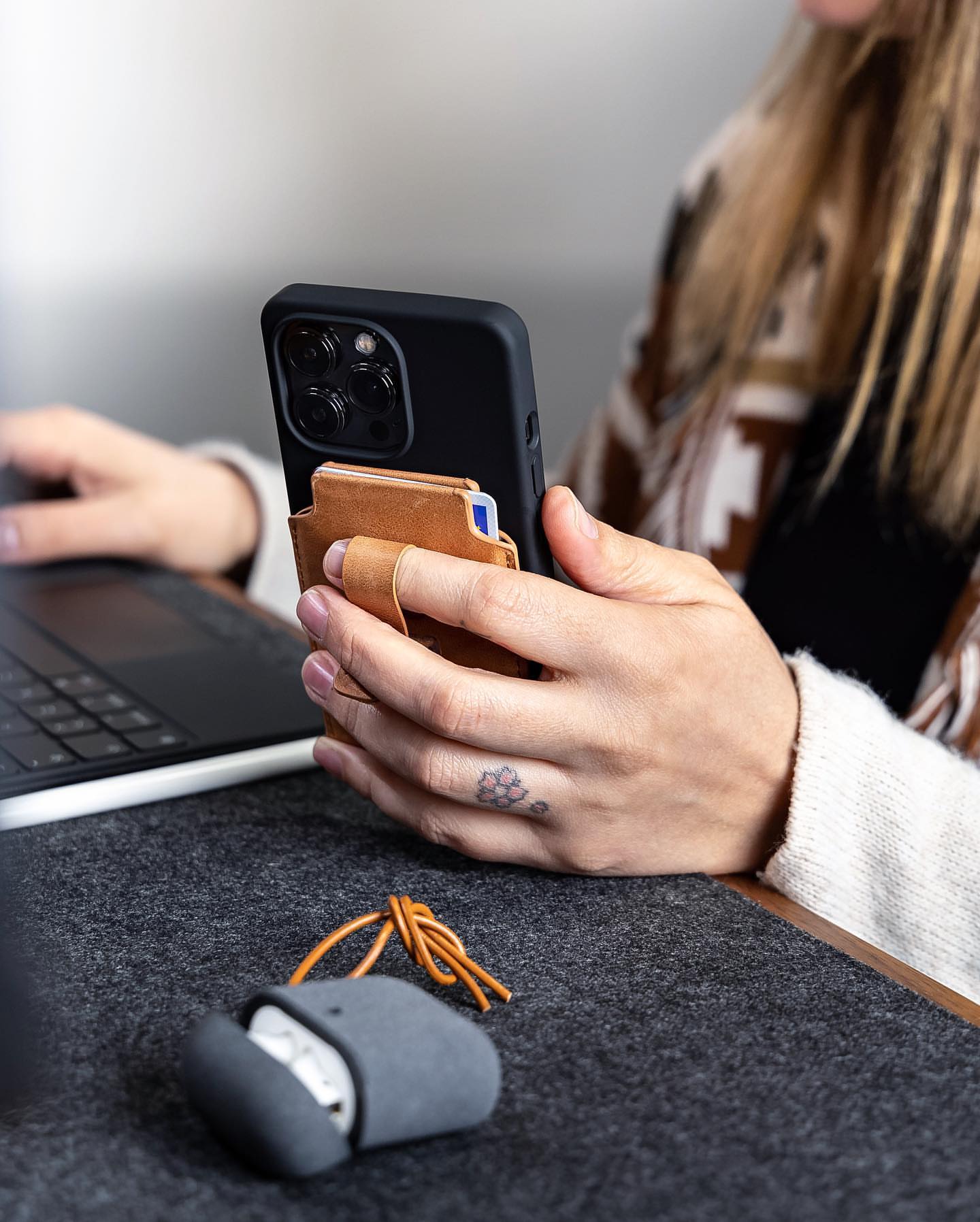 Using MagBak Wallet finger loop to grasp iPhone with one hand. 