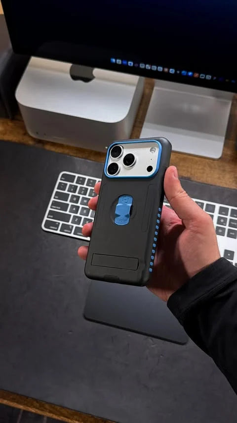Imaad Uddin holding a black and blue MagBak Elite Case for iPhone 17 Pro at a desk